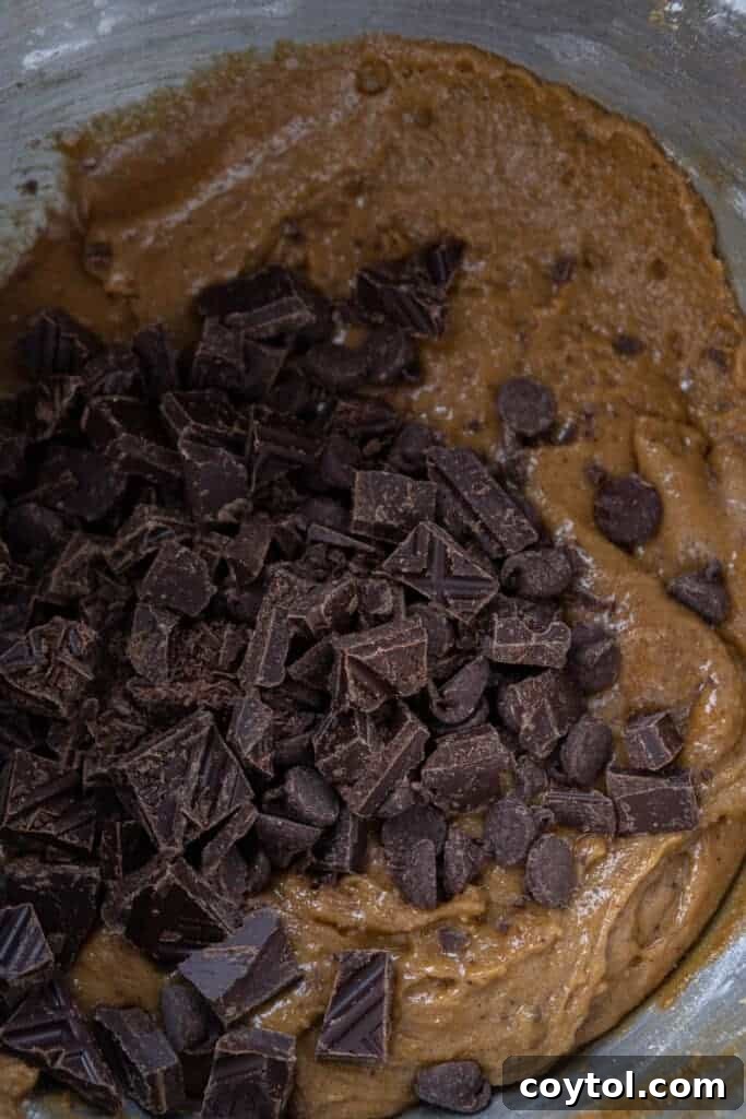 Irresistible Brown Butter Chocolate Chip Blondies 11 chocolate chunks being folded into blondie batter