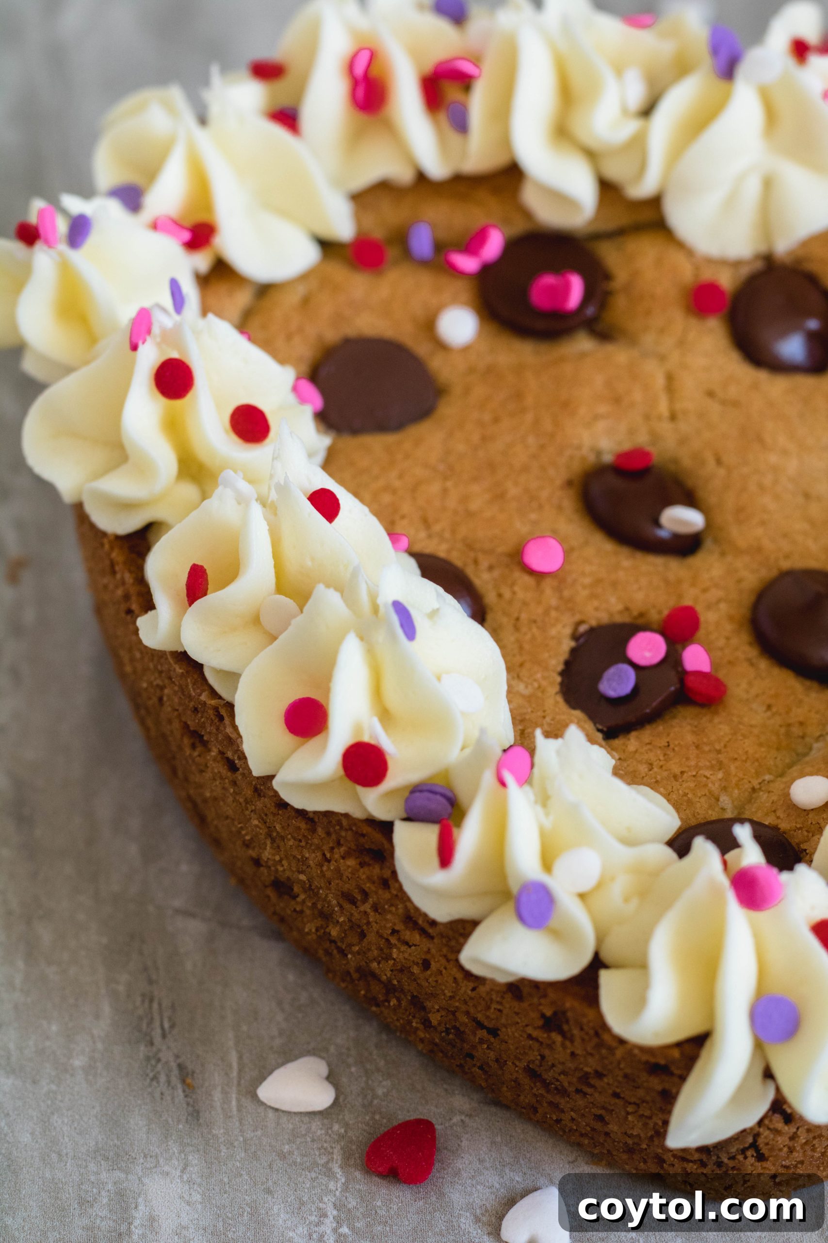 Heart Valentine's Day Cookie Cake for Two, topped with whipped white chocolate ganache and sprinkles