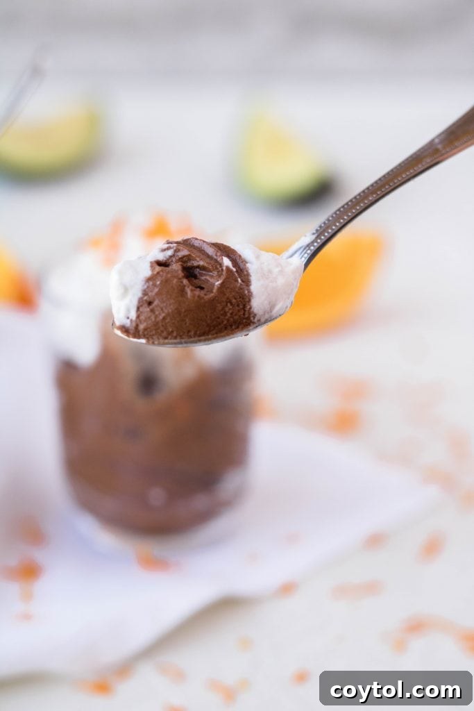 Spoon full of creamy avocado chocolate orange mousse