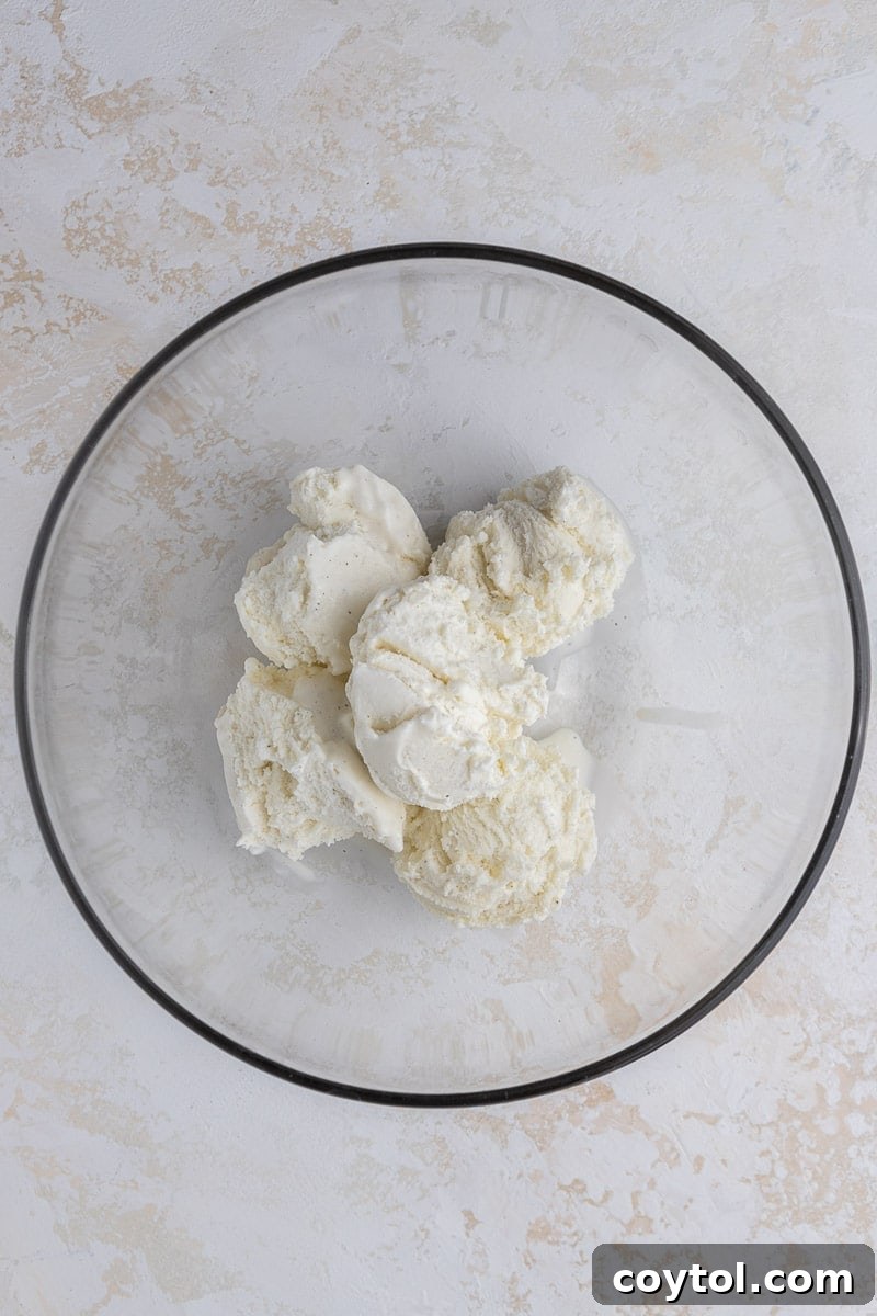 Effortless Indulgence: 3-Ingredient Creme Brulee & Ice Cream 5 Vanilla ice cream melting in a bowl, ready for the creme brulee mixture