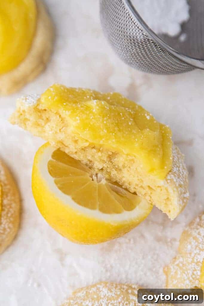 Zesty Chilled Lemon Bar Cookies 10 Half a lemon cookie on a lemon, showing the soft interior