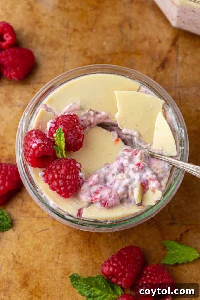 Delicious White Chocolate Raspberry Overnight Oats layered in a jar, ready for breakfast.