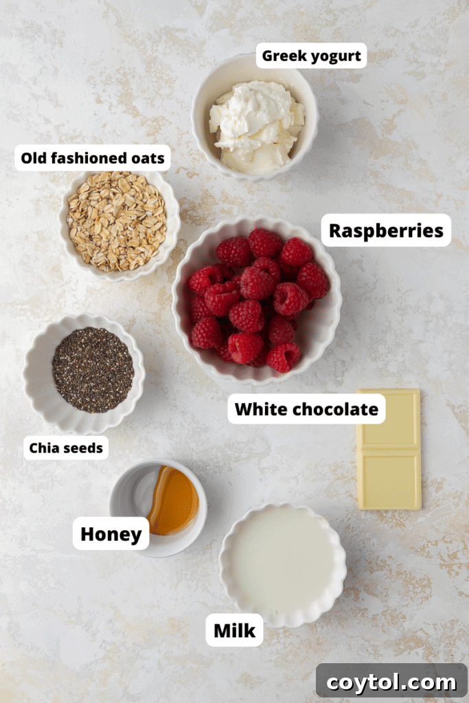 Key ingredients for making white chocolate raspberry overnight oats laid out on a surface.