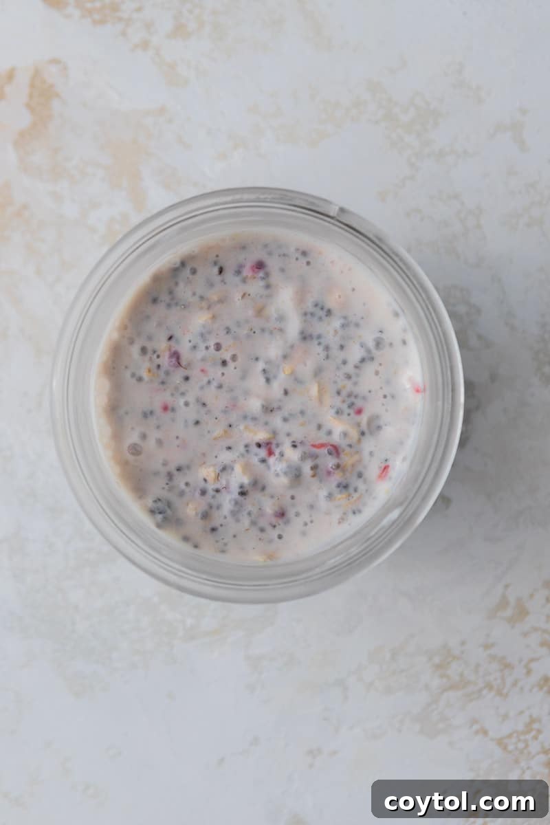 Overnight oat mixture already combined in a cup, ready for chilling.