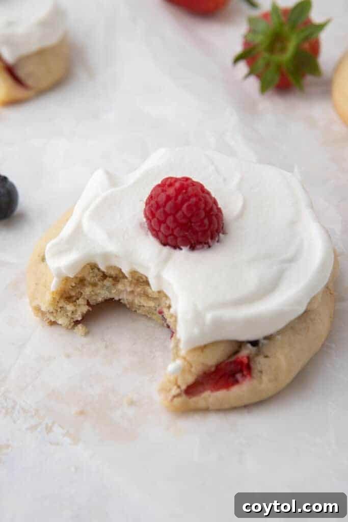 A mini Crumbl Berries and Cream Cookie, showing its smaller size but equally delicious frosting and berry topping.