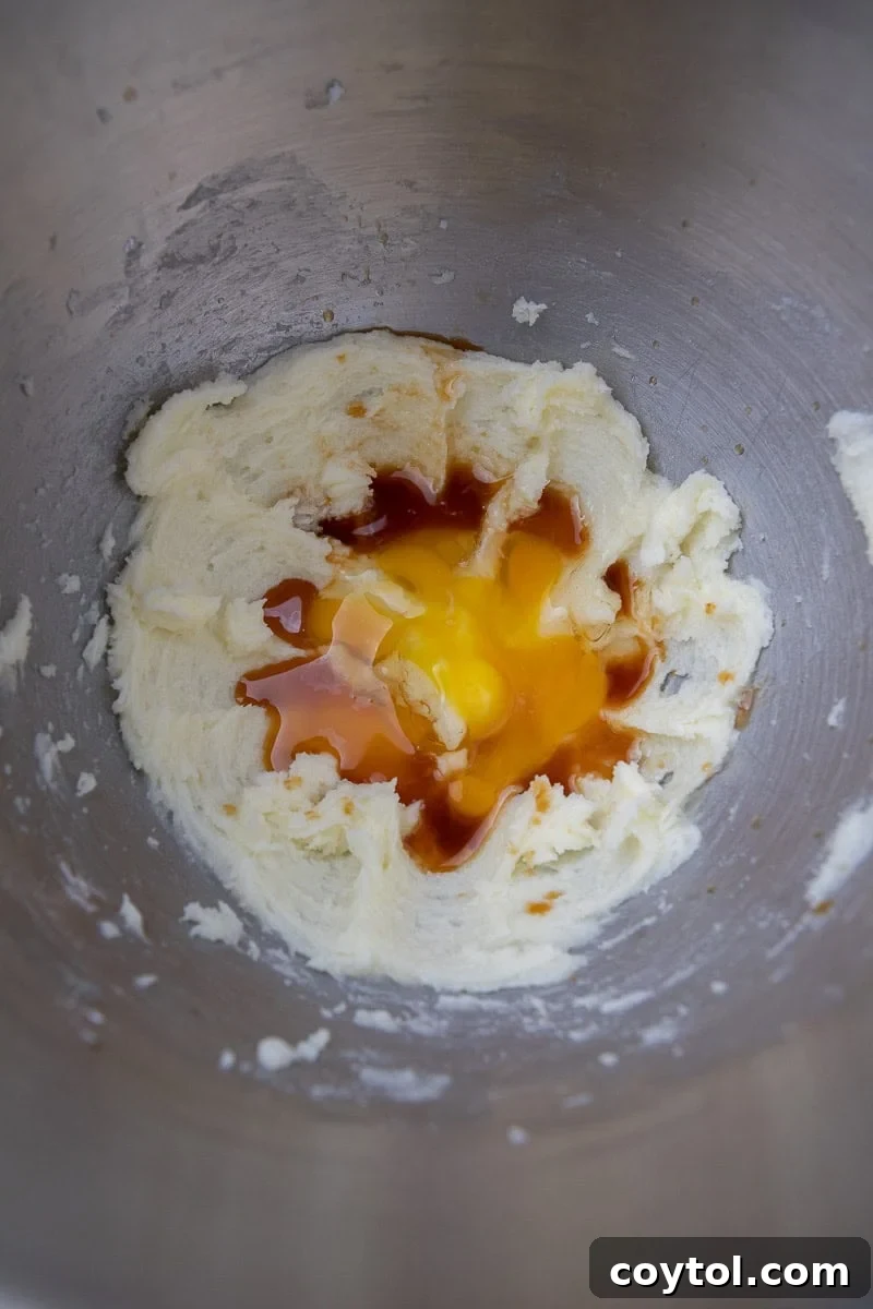 Close-up of creamed butter and eggs in a mixing bowl, showing the light and fluffy texture.