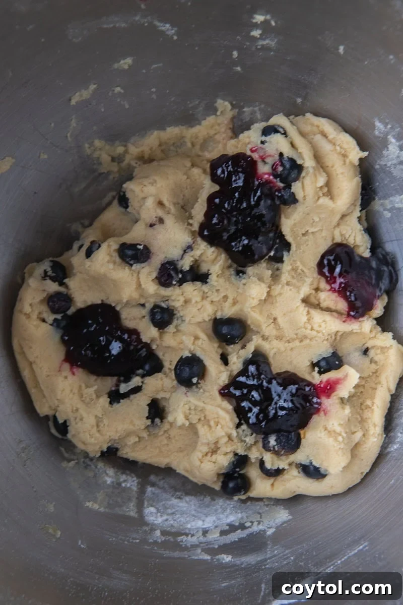 Blueberry Muffin Cookie Bliss: Crumbl-Style with Streusel 6 Blueberry cookie dough with fresh blueberries in mixing bowl