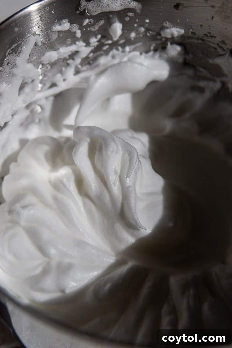 Whipped egg whites in a clean bowl