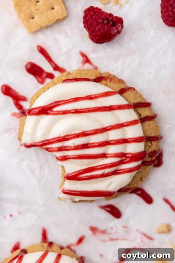 Irresistible Crumbl Raspberry Cheesecake Cookies 2 Decadent Crumbl Raspberry Cheesecake Cookies with creamy frosting and raspberry drizzle