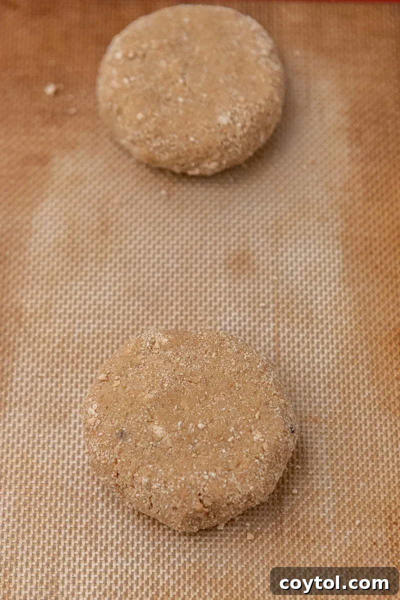 Irresistible Crumbl Raspberry Cheesecake Cookies 8 Flattened cookie dough on a parchment-lined baking sheet