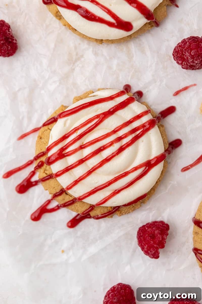 Irresistible Crumbl Raspberry Cheesecake Cookies 10 Freshly baked Crumbl Raspberry Cheesecake Cookies on a cooling rack