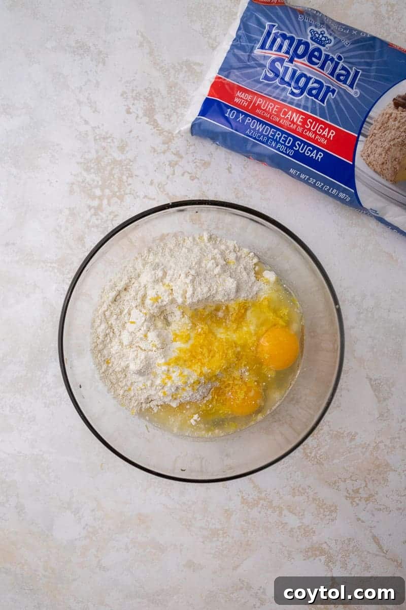 Mixing bowl with ingredients for lemon crinkle cookies