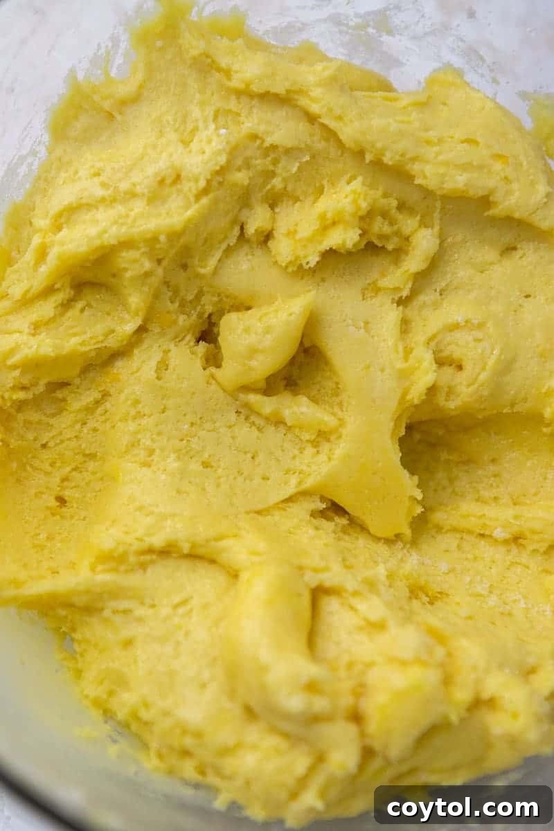 Yellow cookie dough in a mixing bowl