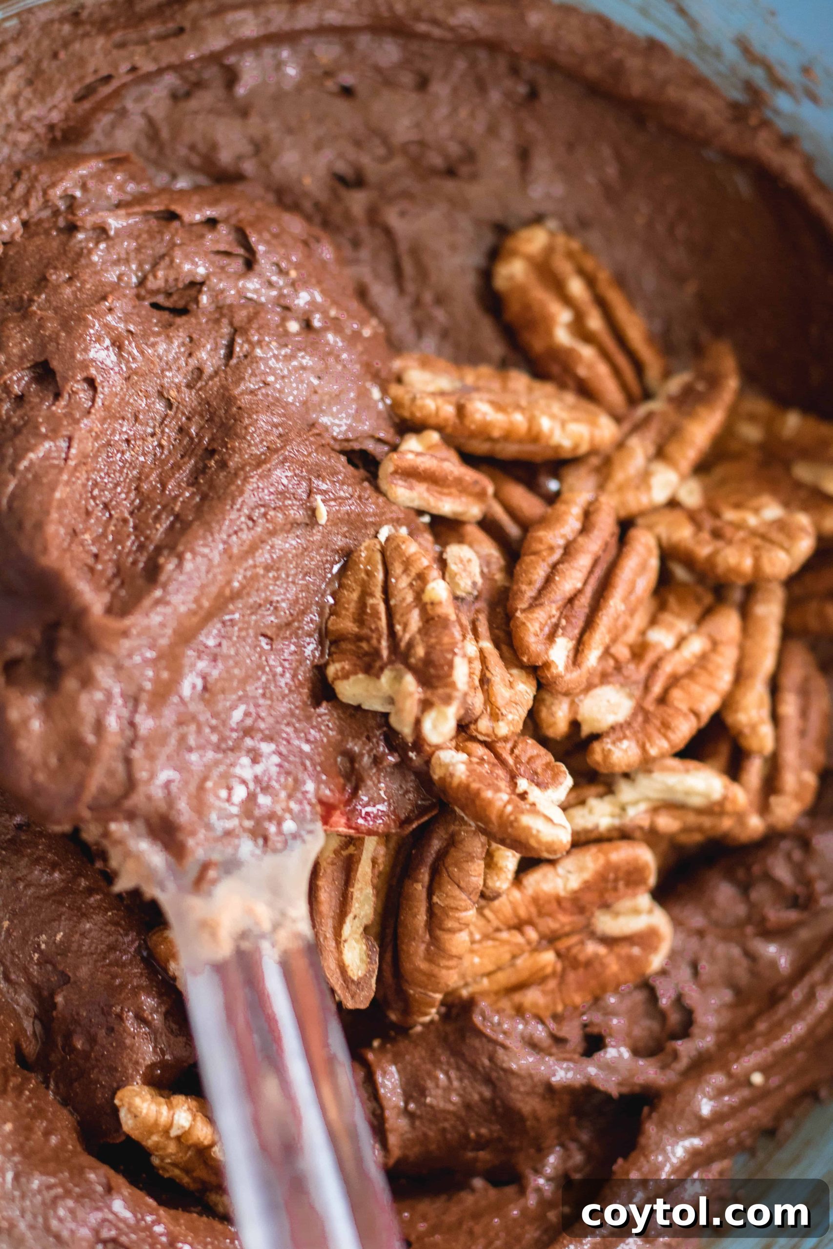 adding nuts to the brownies