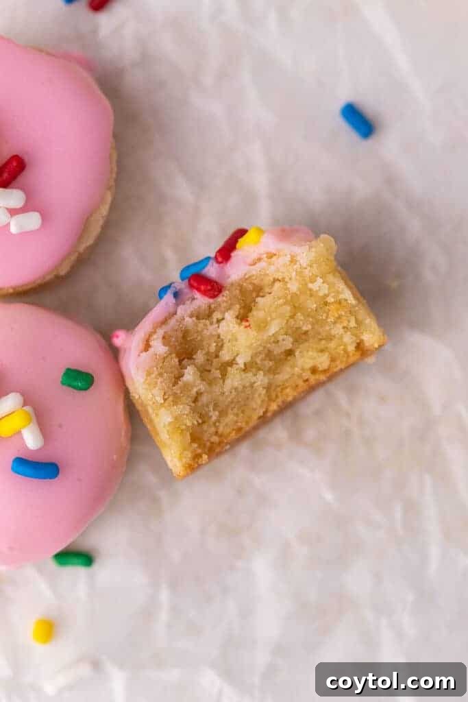 A plate of pink donut hole cookies, showing the delightful miniature versions