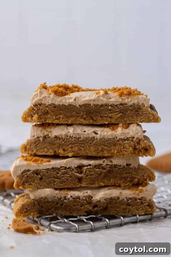 Crumbl's Chilled Cookie Butter Ice Cream Cookies 12 A stack of Crumbl cookie butter ice cream cookies, showing their impressive height and frosting.