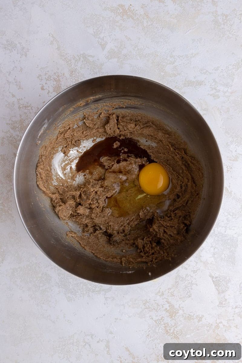 Crumbl's Chilled Cookie Butter Ice Cream Cookies 5 Creamed butter and egg mixture in a mixing bowl.