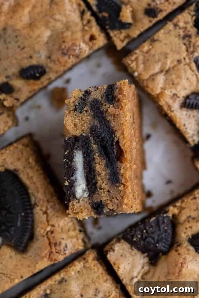 Overhead view of a tray of freshly baked Oreo blondies, perfectly sliced into uniform squares, ready to be served.