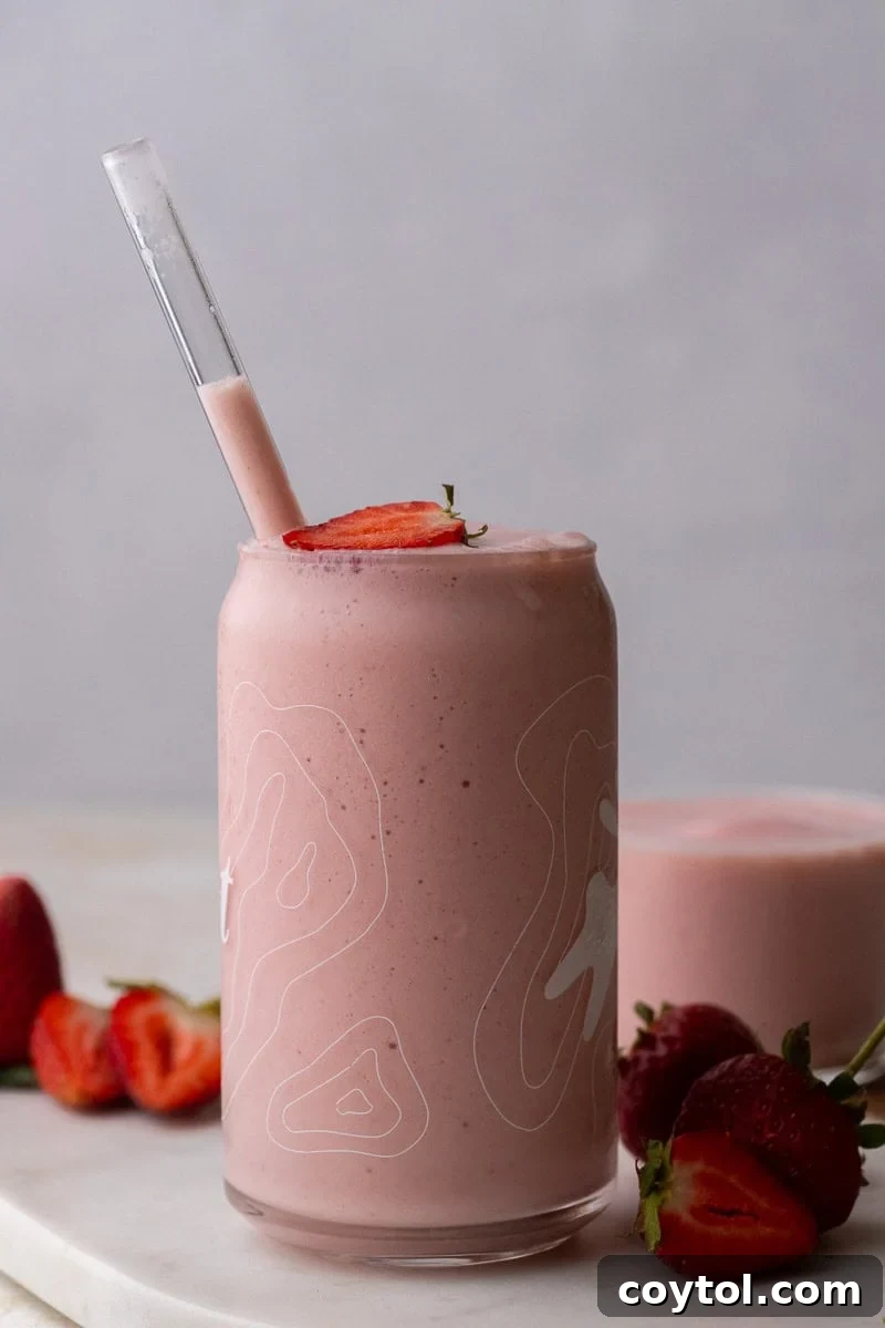 Freshly poured strawberry banana smoothie in a glass