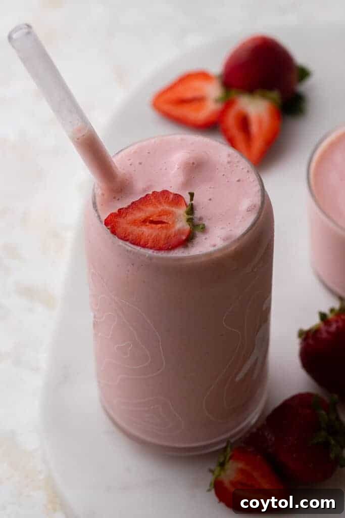 McDonald's strawberry banana smoothie copycat in a tall glass with a straw