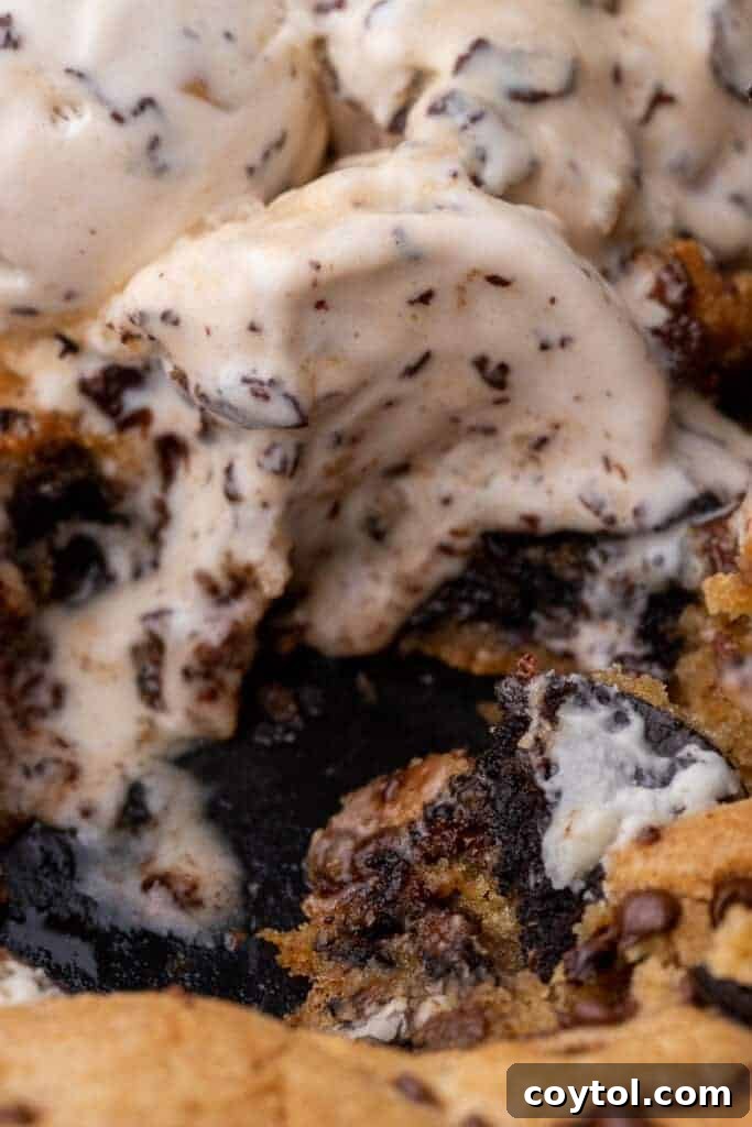 Simple Skillet Oreo Cookies and Cream Pizookie 9 Close-up of a skillet dessert, revealing its chewy texture and chocolatey goodness.