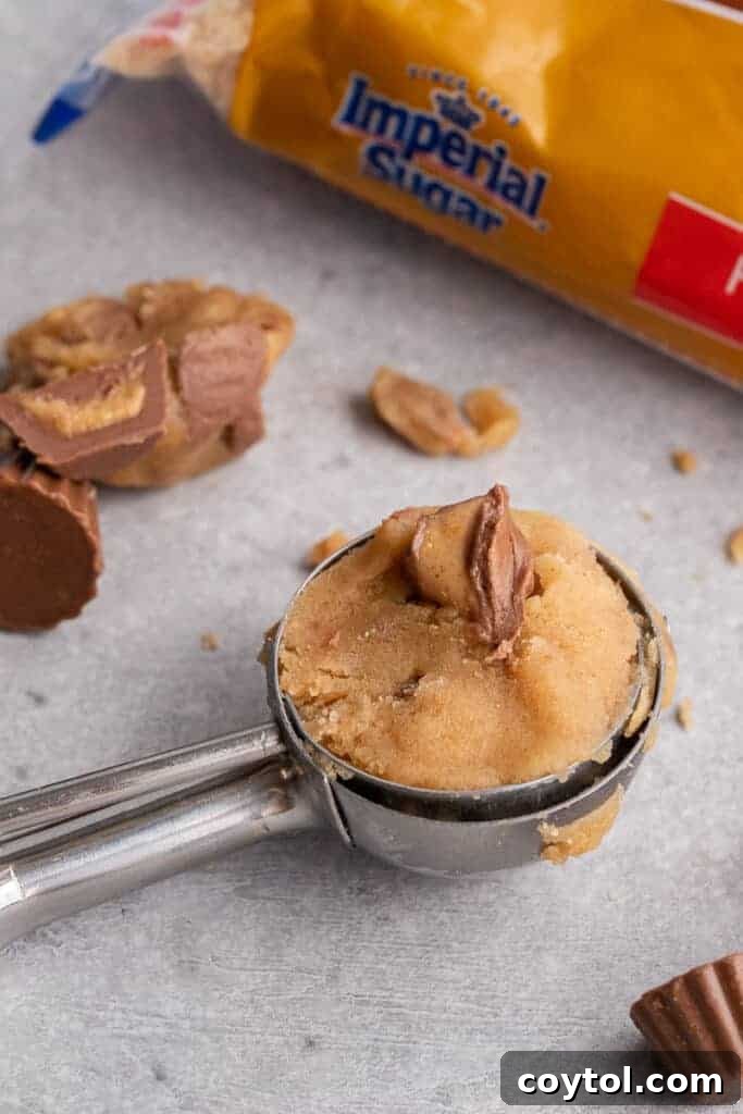 Edible peanut butter cookie dough in a cookie scoop, ready to be enjoyed