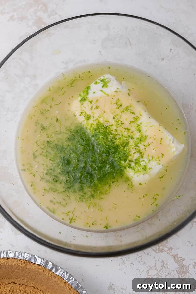 Ingredients for key lime pie being mixed in a bowl