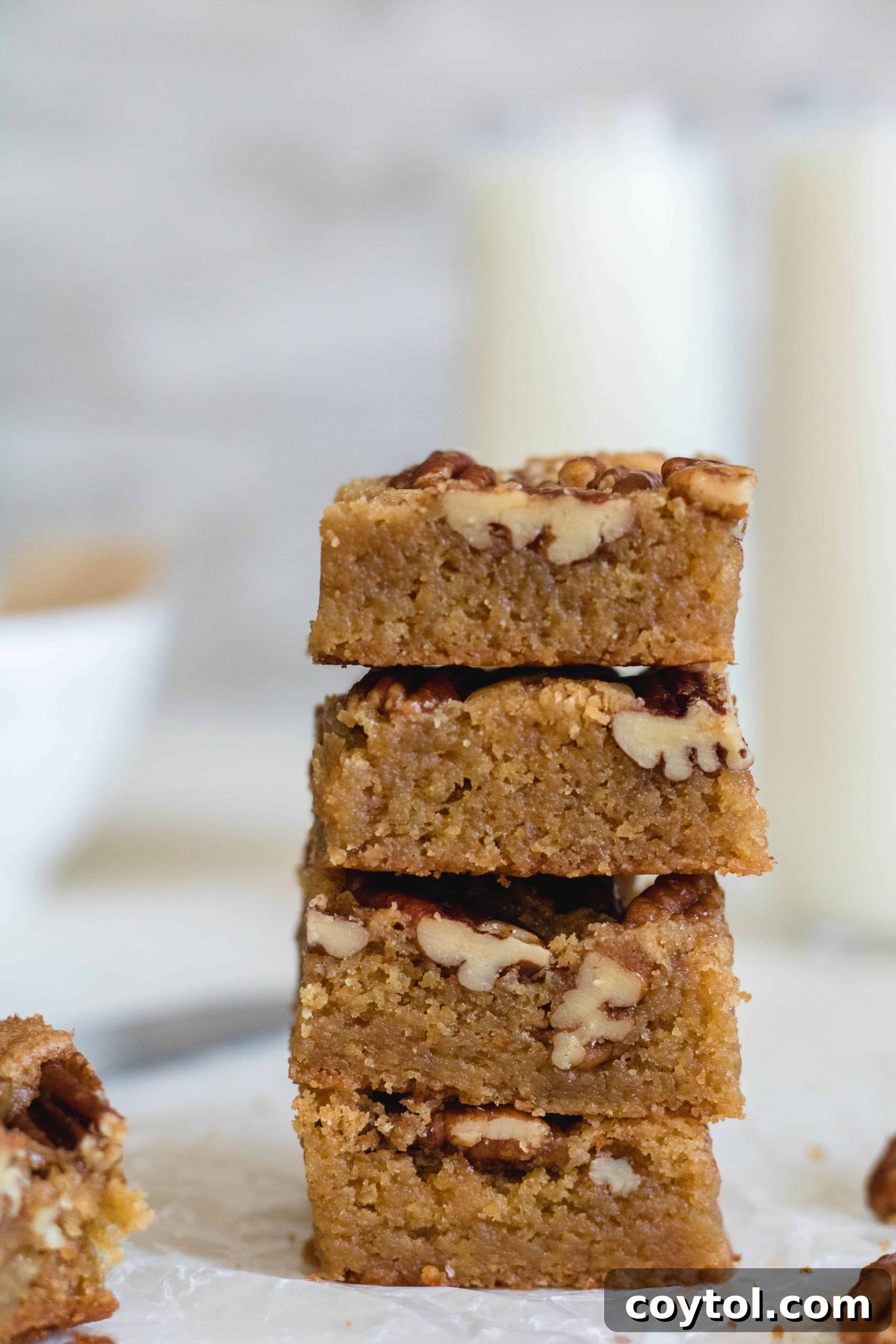Stacked brown butter pecan blondies with a golden hue, invitingly soft and chewy texture.