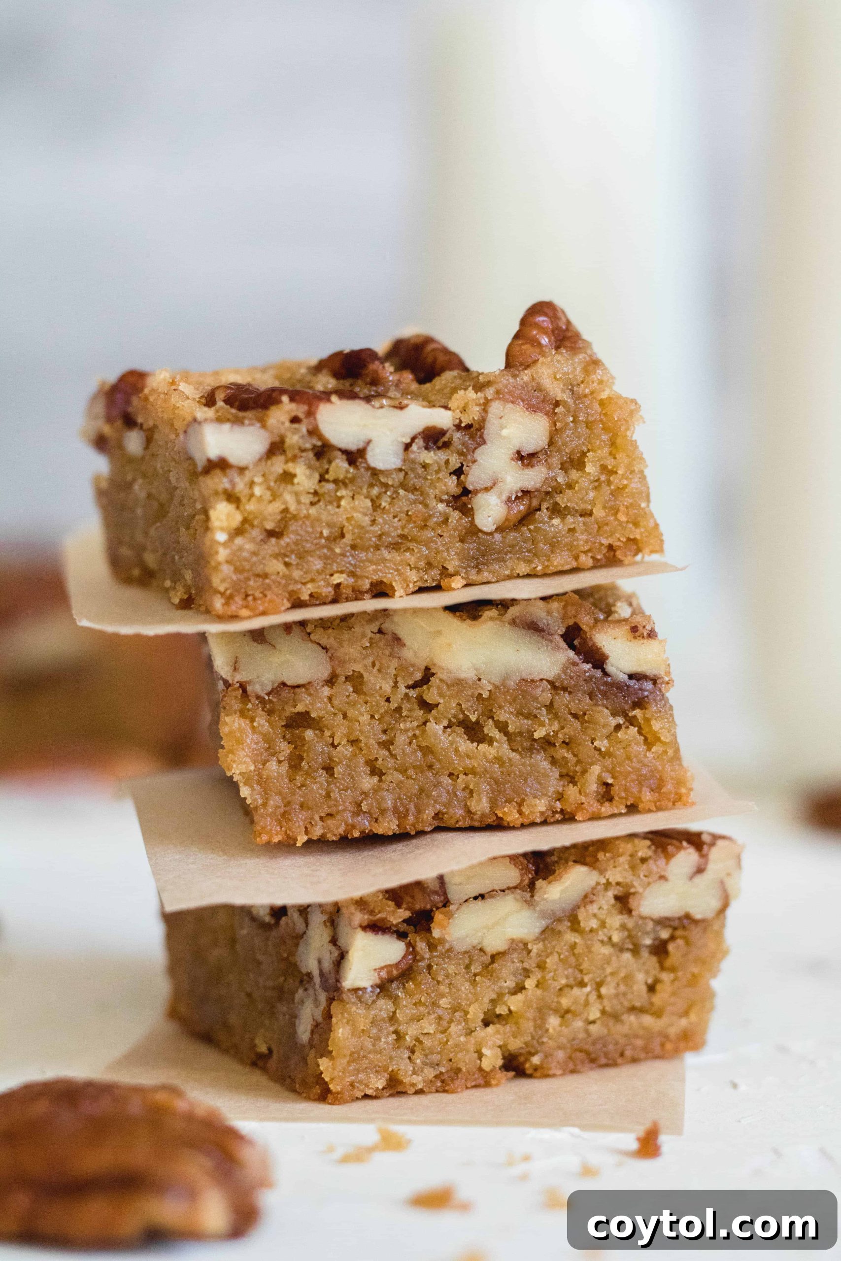 Close-up of a single brown butter candied pecan blondie, highlighting its irresistible texture and topping, truly the best blondies in the world.