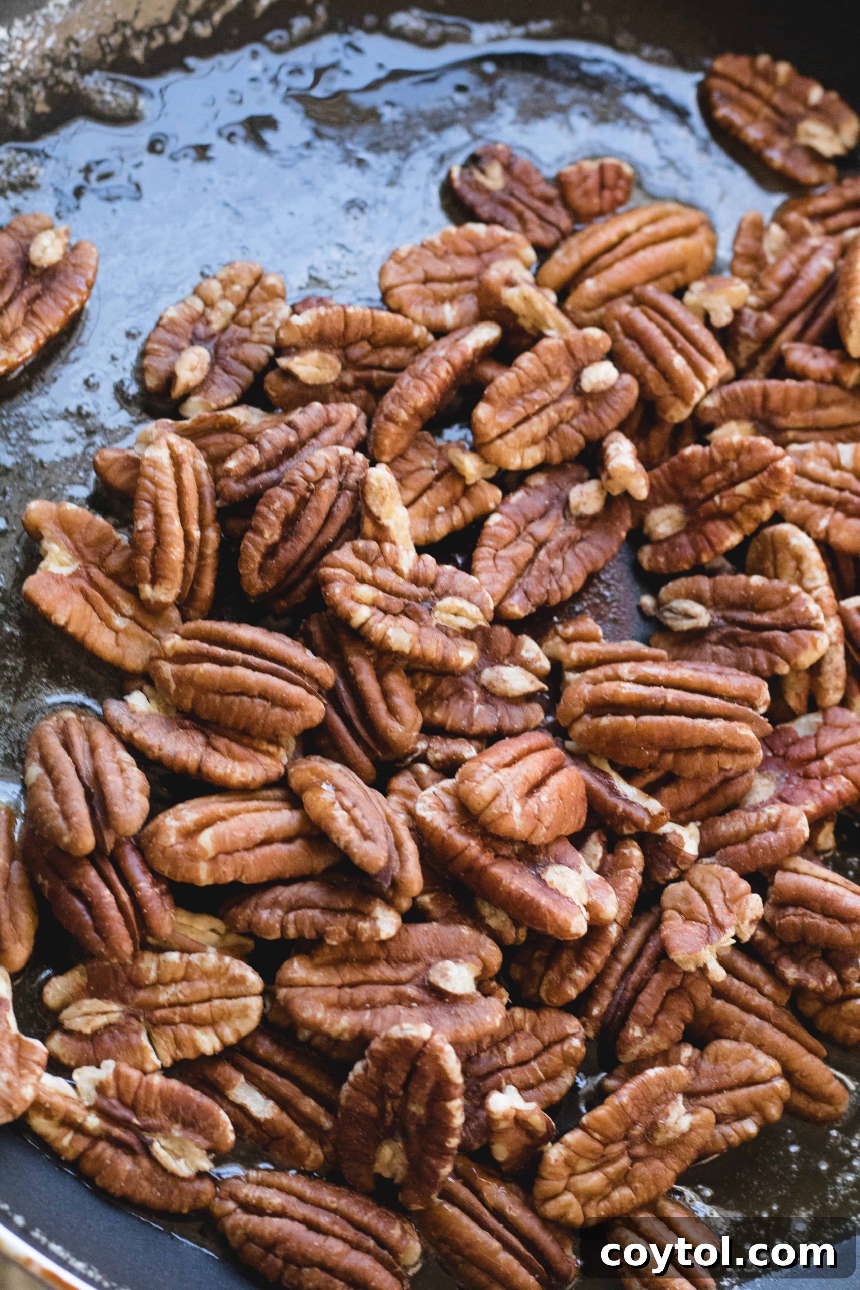 A baking sheet lined with parchment paper, prepped for candied pecans.