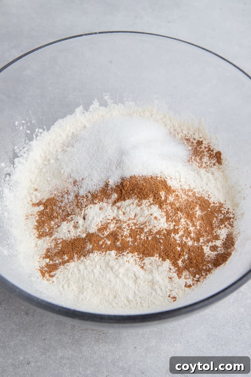 Dry pancake mix, sugar, and pumpkin pie spice blended in a bowl.