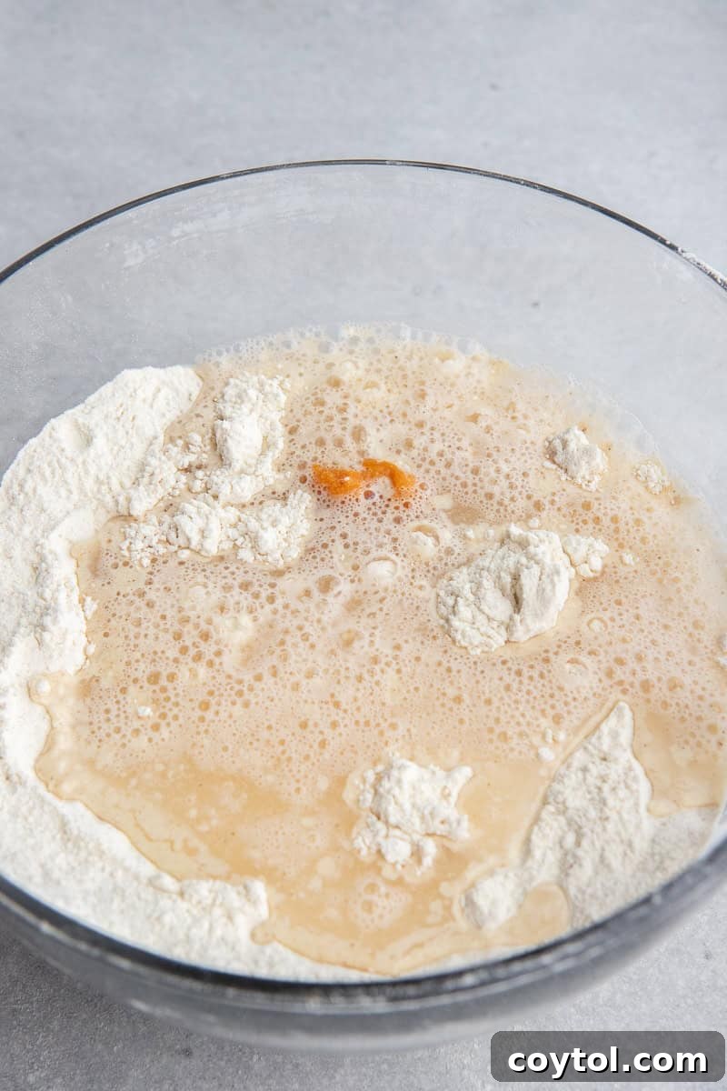 Adding pumpkin puree and vanilla extract to the dry pancake mixture.