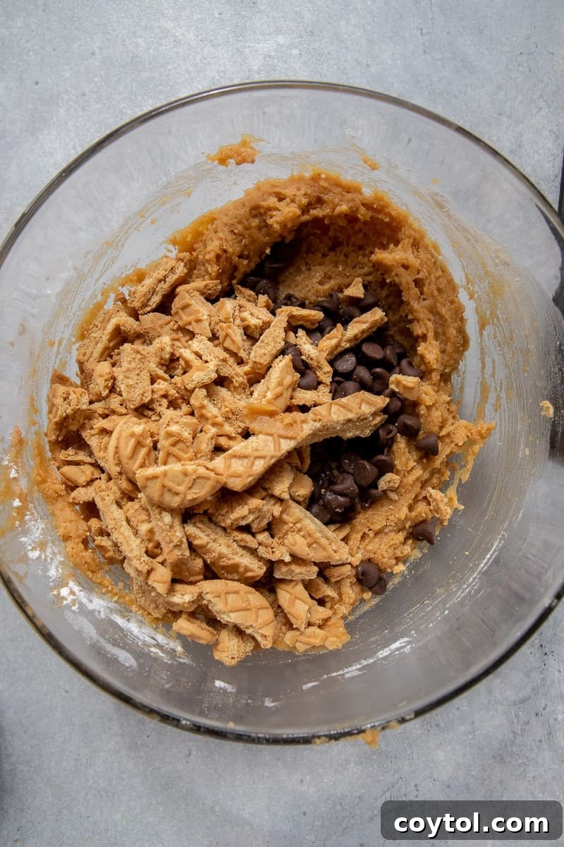 The blended cookie dough with Nutter Butter pieces and chocolate chips, ready for baking.