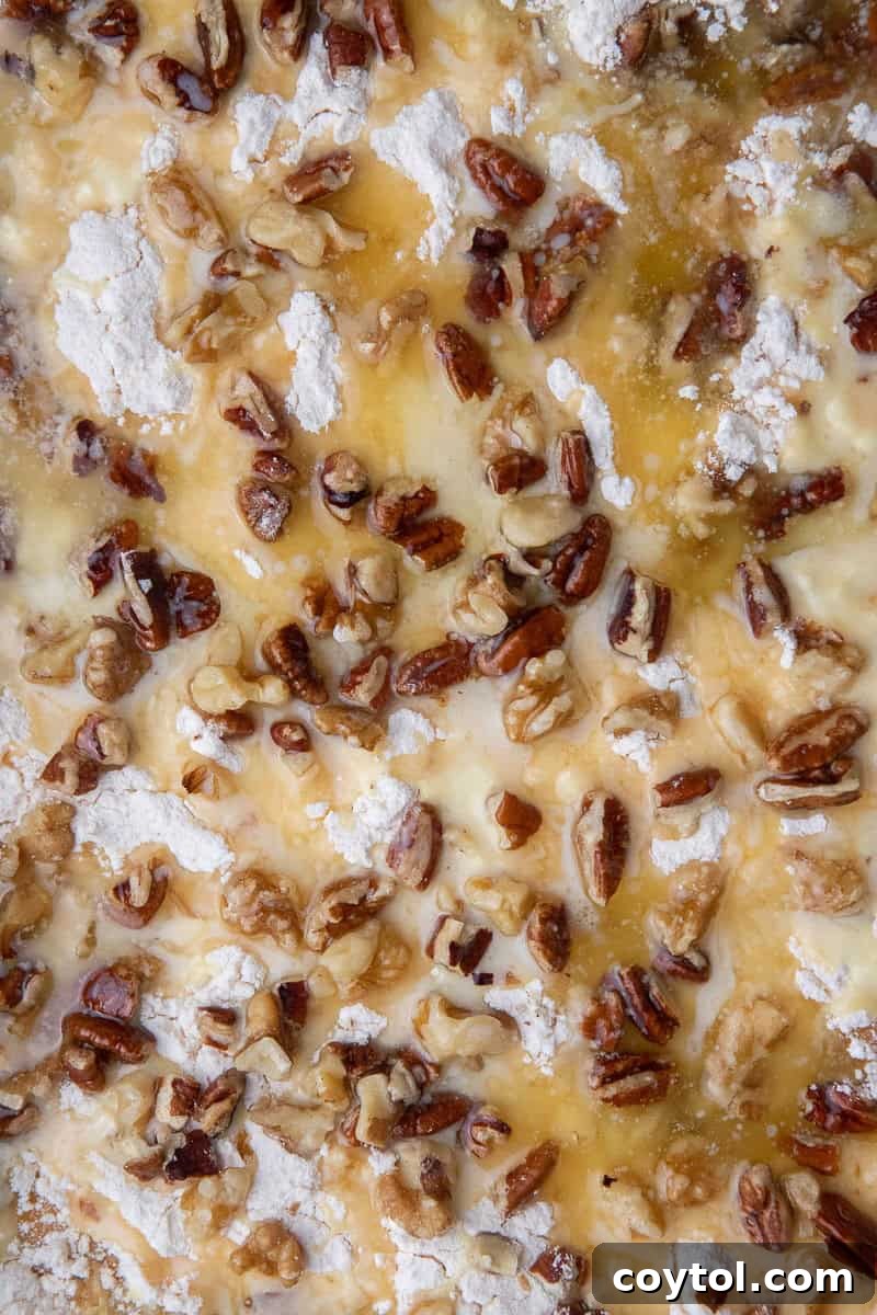 Close up of cake mix and pecan layer with butter