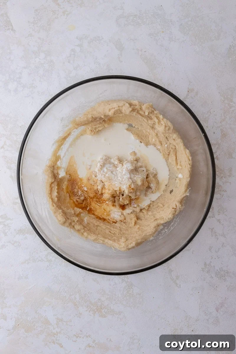 Wet ingredients (butter, sugar, vanilla, cream) in a mixing bowl