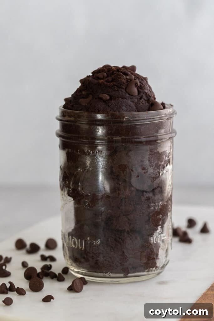 Edible brownie batter in a bowl with a spoon