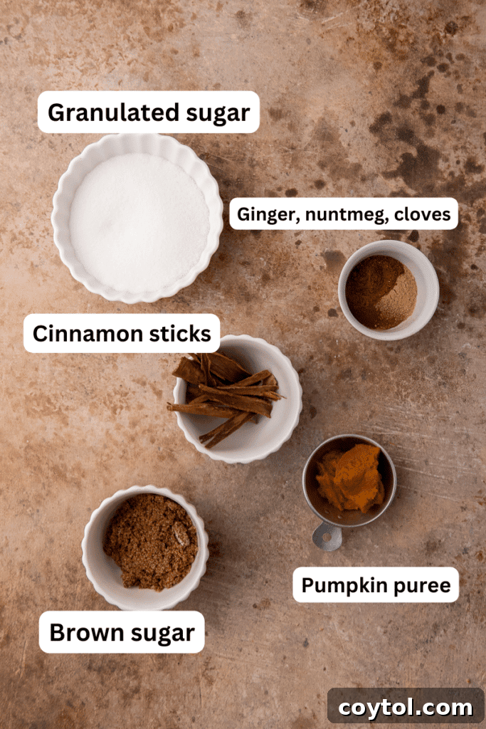 Ingredients for pumpkin spice syrup laid out on a wooden table