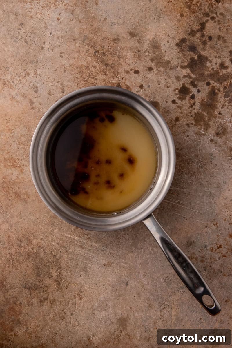 Water and sugar being combined in a pot