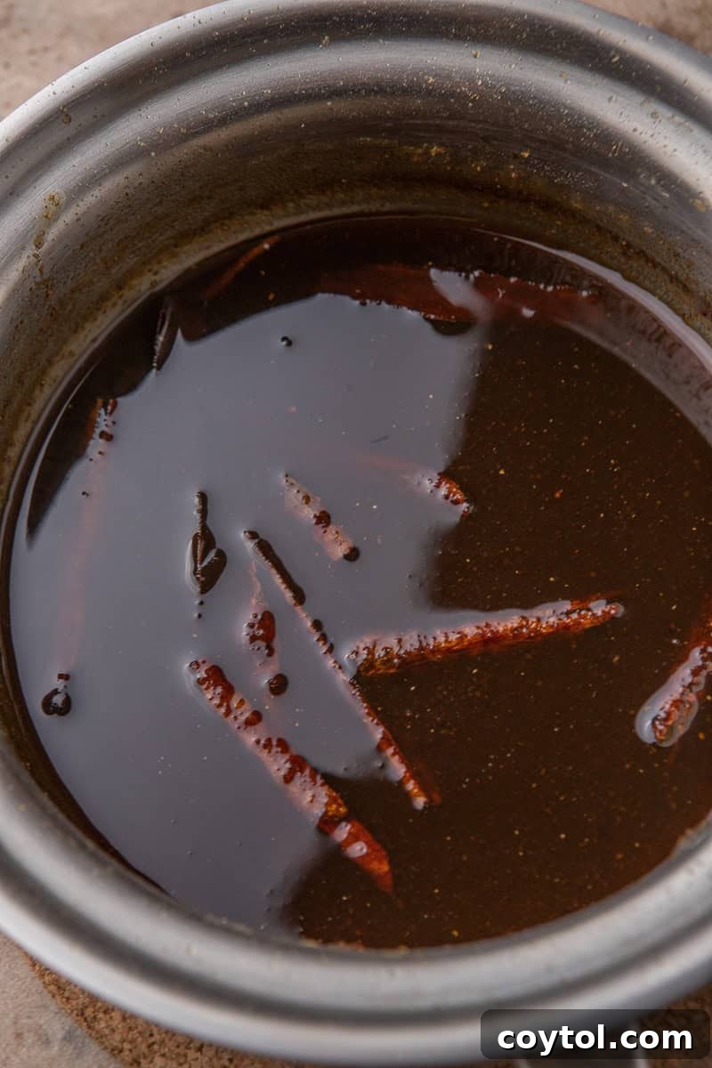 Thickened pumpkin spice syrup simmering in a pan