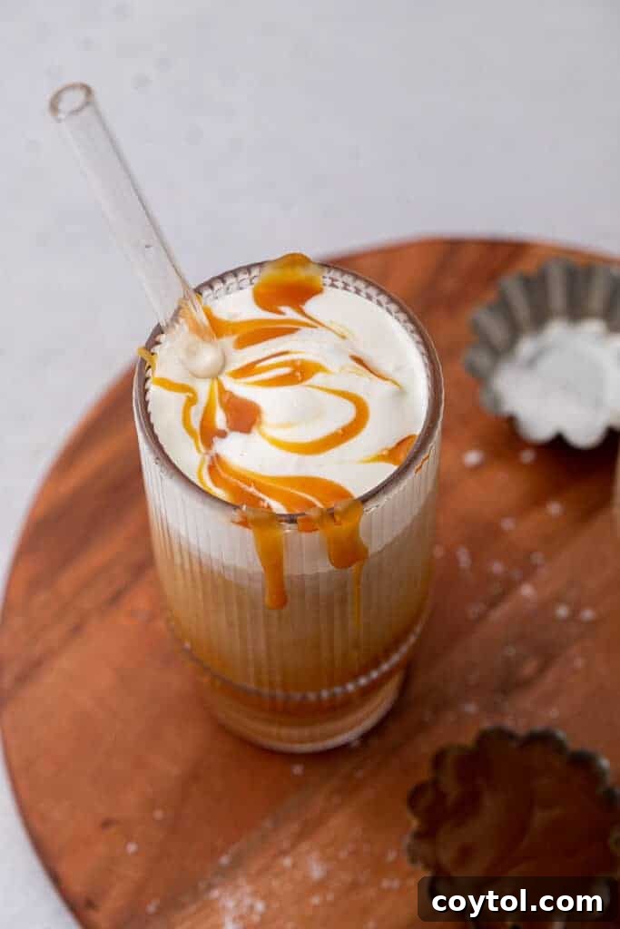 Craft Your Own Starbucks Salted Caramel Cold Foam Cold Brew 11 A glass of Starbucks-style salted caramel cold brew with foam