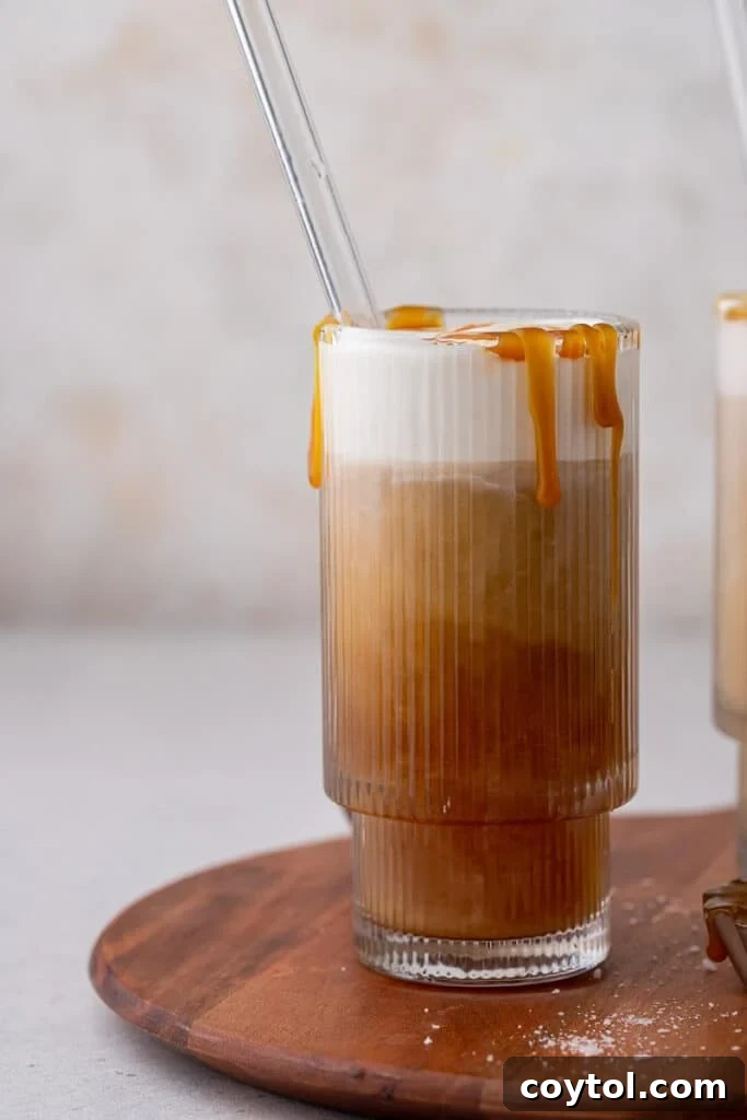 Craft Your Own Starbucks Salted Caramel Cold Foam Cold Brew 3 Homemade salted caramel cold foam cold brew recipe in a glass on a wooden table