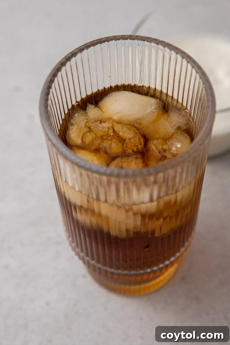 Craft Your Own Starbucks Salted Caramel Cold Foam Cold Brew 6 Cold brew coffee poured into a glass with ice
