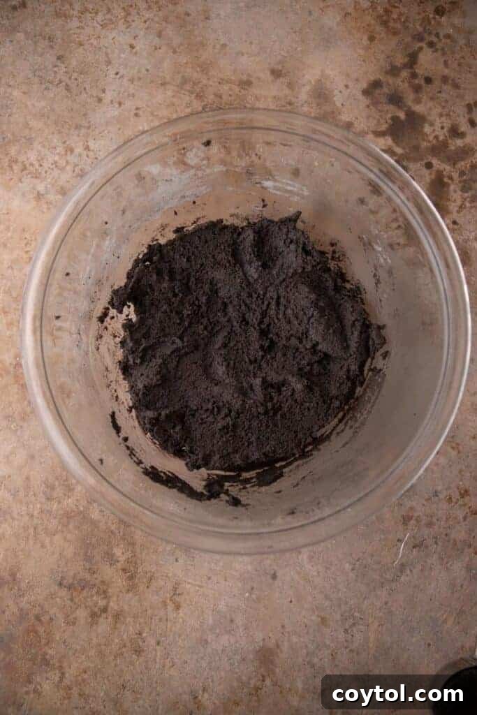 Crumbl's Mallow Oreo Dream Sandwich 6 Black cocoa powder cookie dough in a bowl