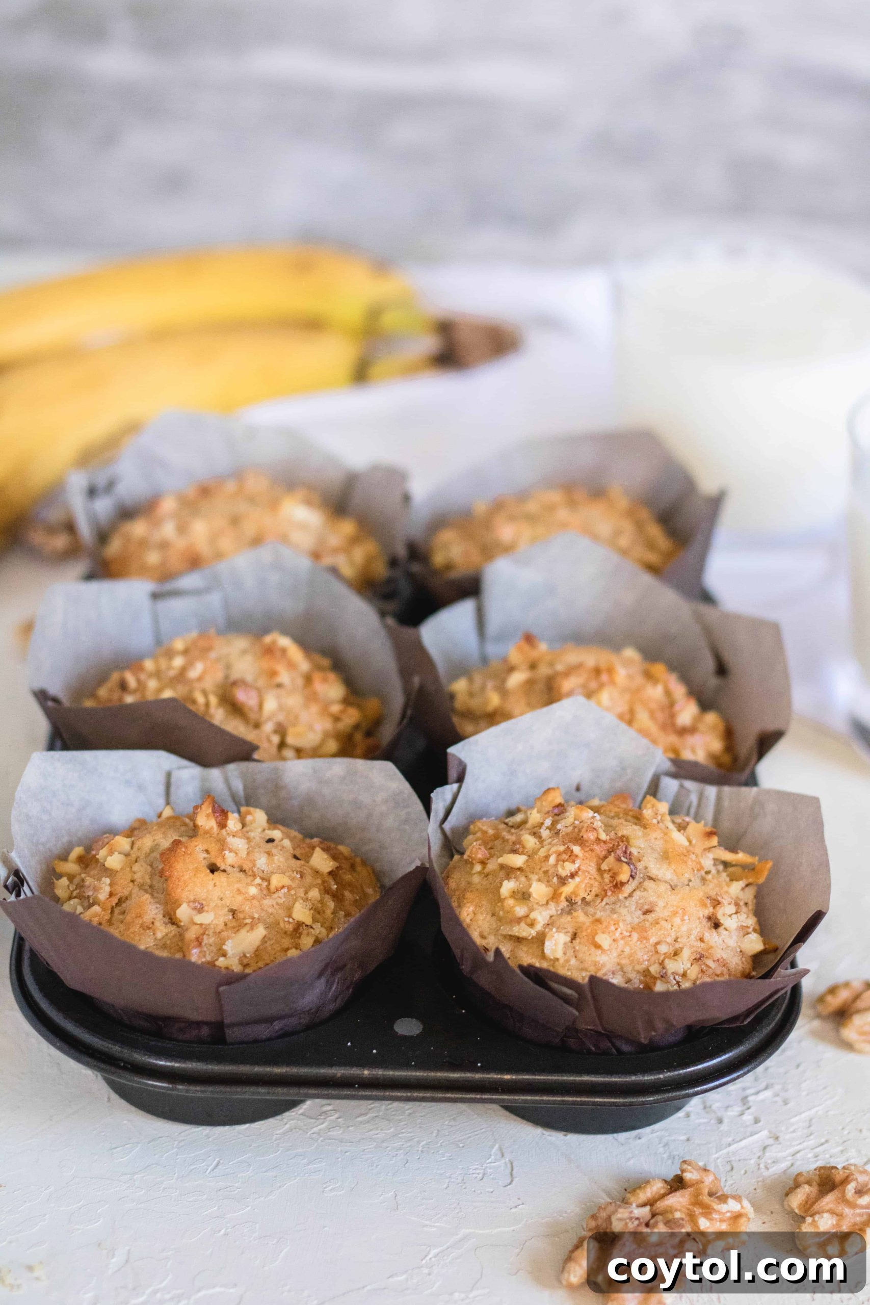 Baked banana nut muffins on a cooling rack.