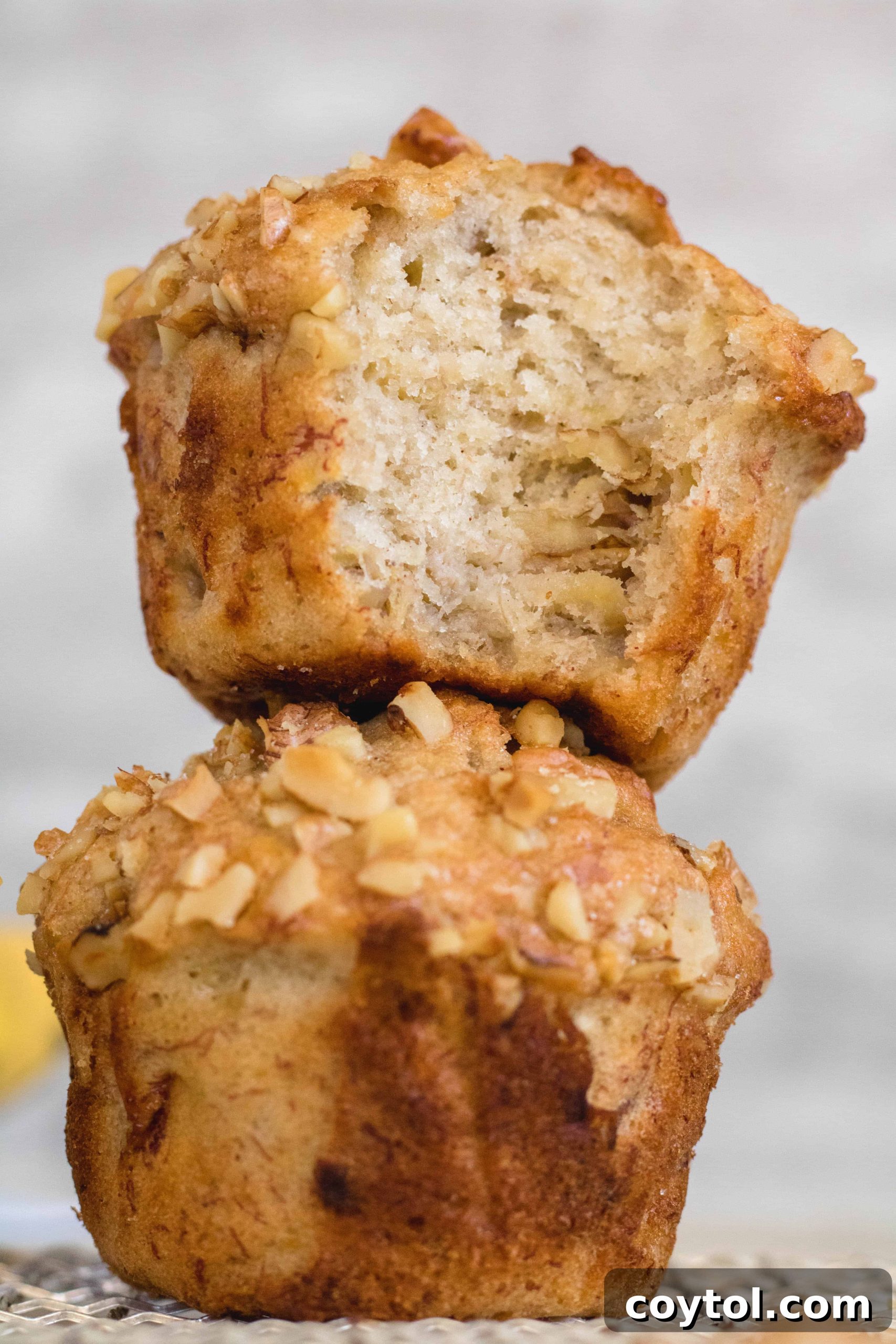 High banana walnut muffin recipe, showing a tall, domed muffin.