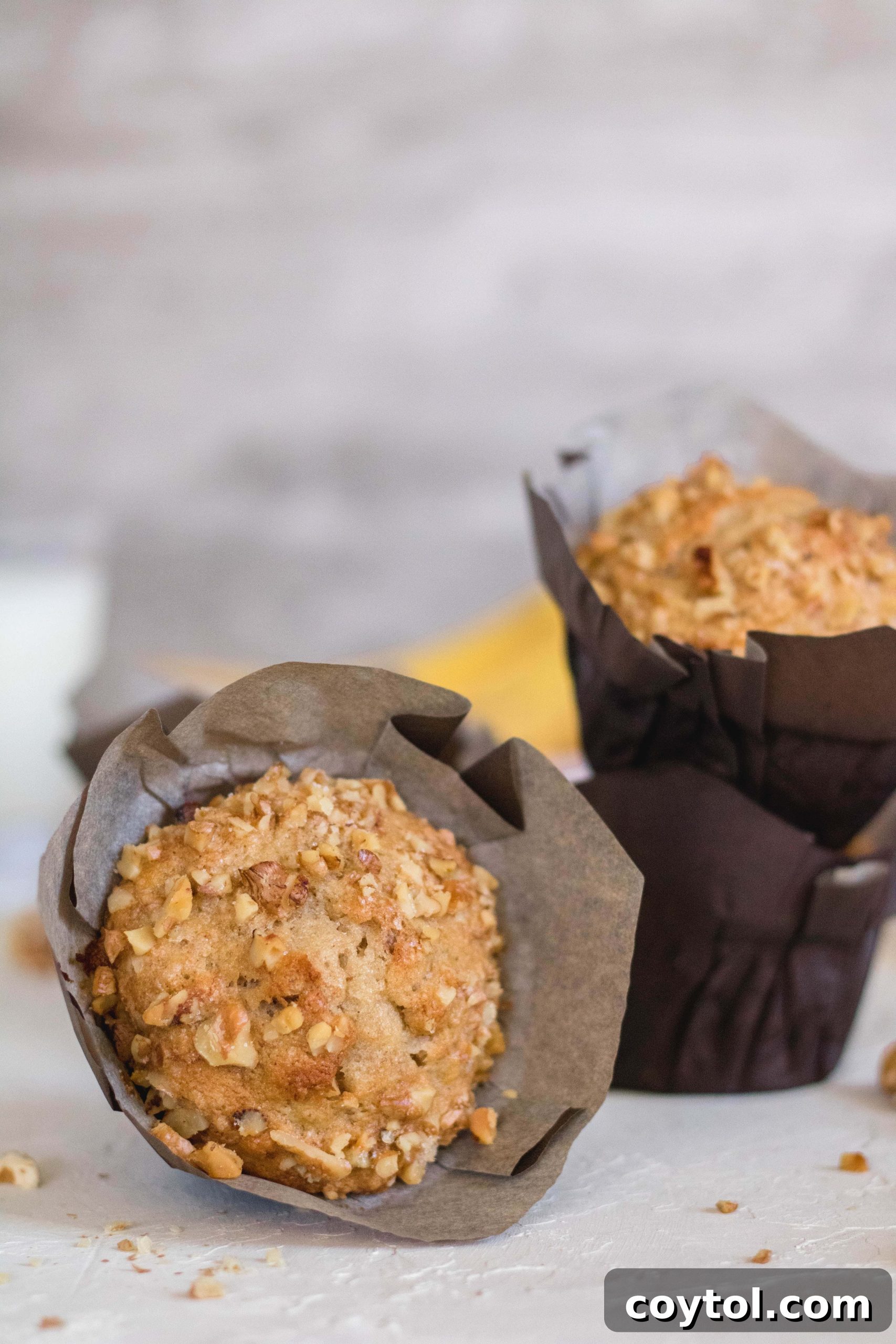Banana walnut muffin tilted to show its texture.