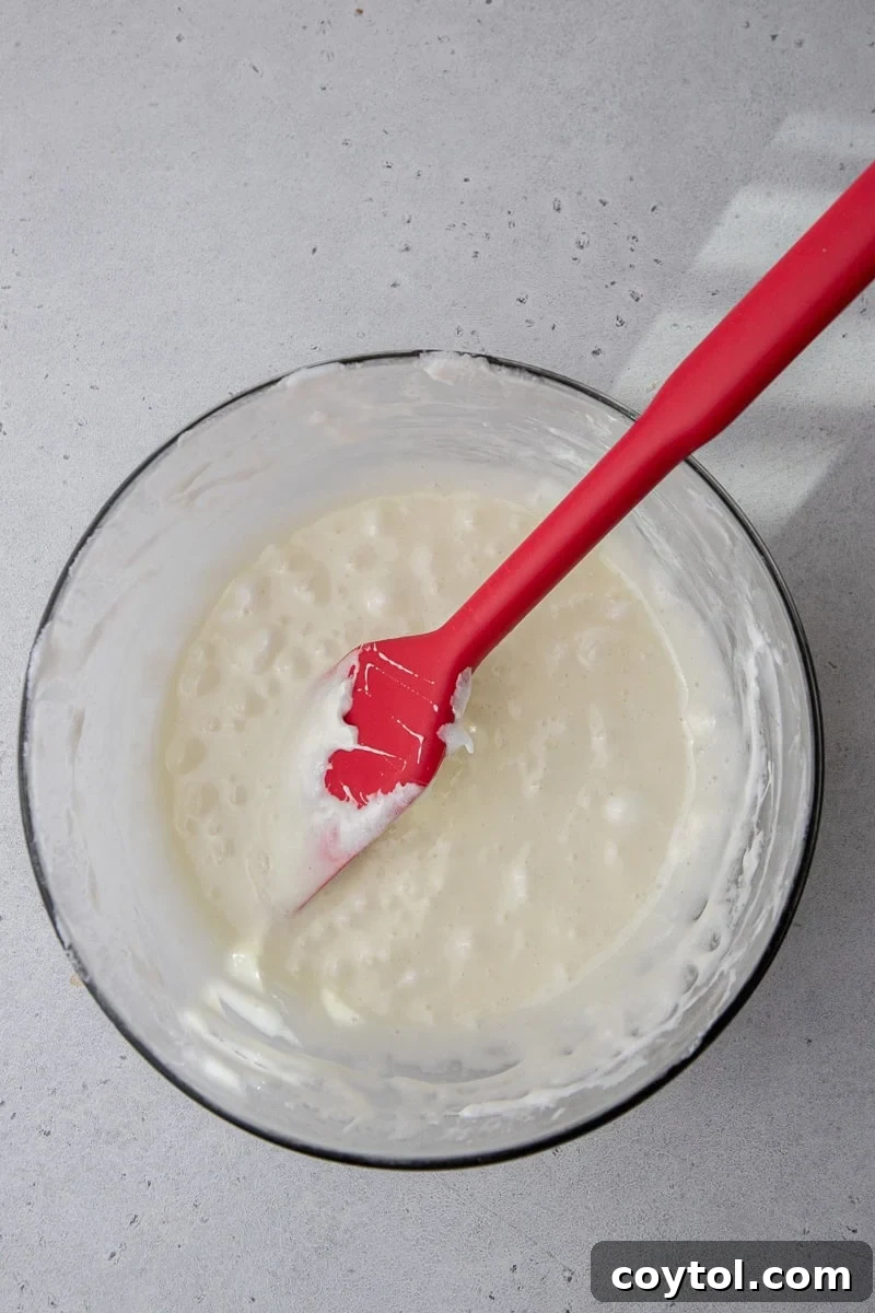 Crumbl-Style No-Bake Rice Krispies Treats 5 Marshmallows and butter in a bowl