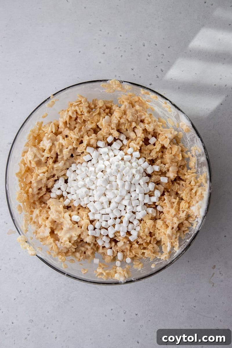 Crumbl-Style No-Bake Rice Krispies Treats 6 Rice Krispies and marshmallow mixture in a bowl