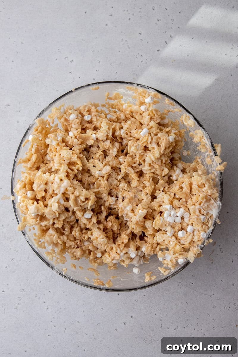 Crumbl-Style No-Bake Rice Krispies Treats 7 Rice Krispies and marshmallow mixture in a bowl
