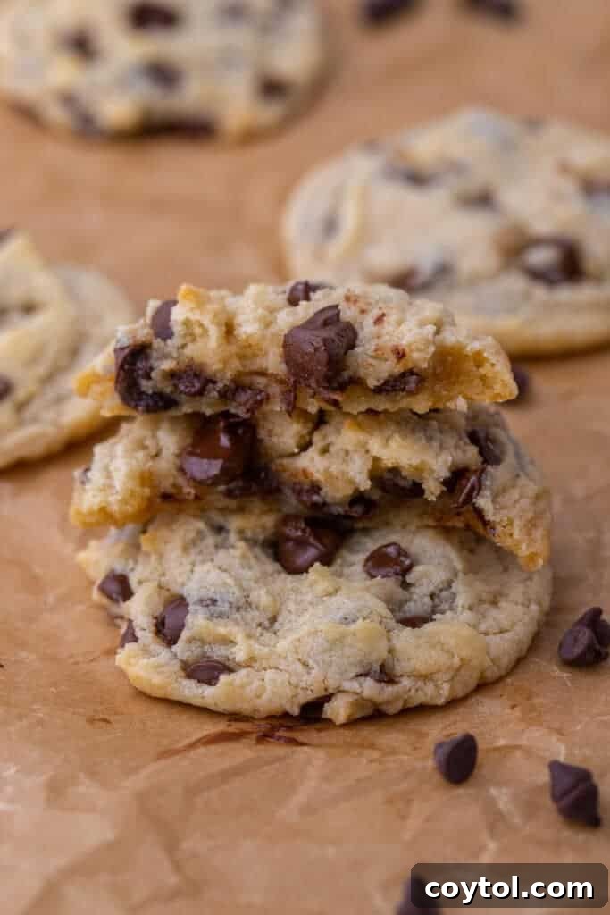 A broken stack of no-egg chocolate chip cookies, highlighting their soft texture and rich chocolate.